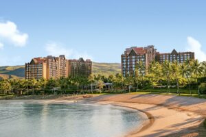 aulani, a disney resort & spa property showing the water nearby and the resort buildings