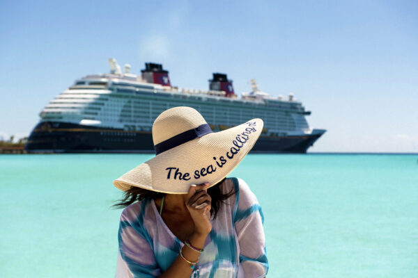 Woman standing in front of disney cruise line ship