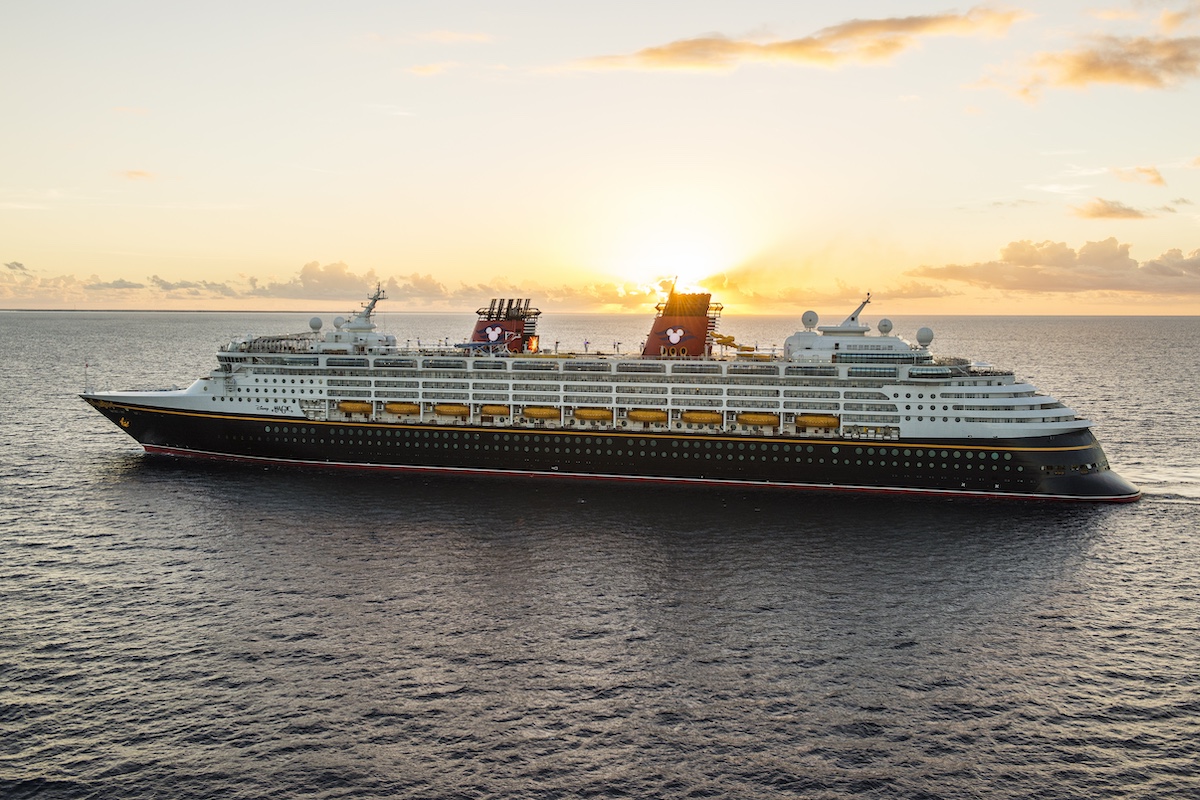 Disney Magic cruise ship at sea during sunset