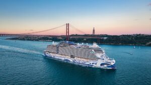the norwegian viva sailing near the city of lisbon
