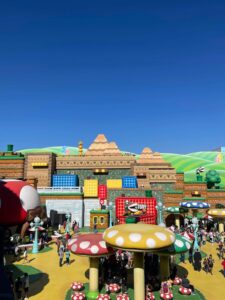 Super Nintendo World environment including piraña plants and giant mushrooms