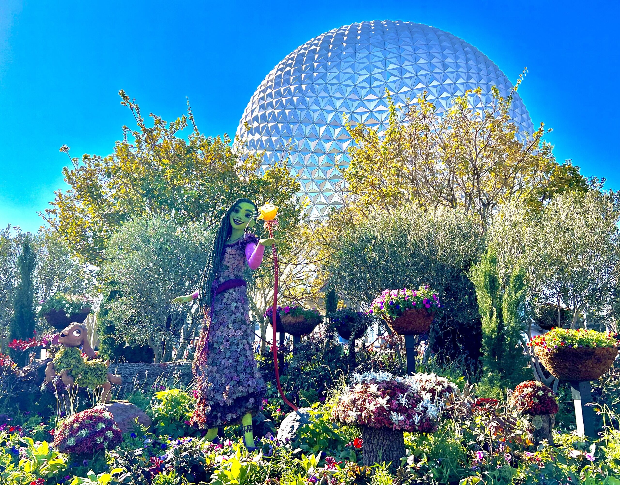 wish themed topiary in front of spaceship earth