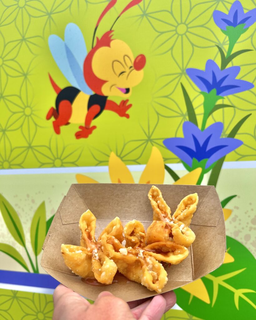 cheesy crab wontons in front of bee photo at EPCOT