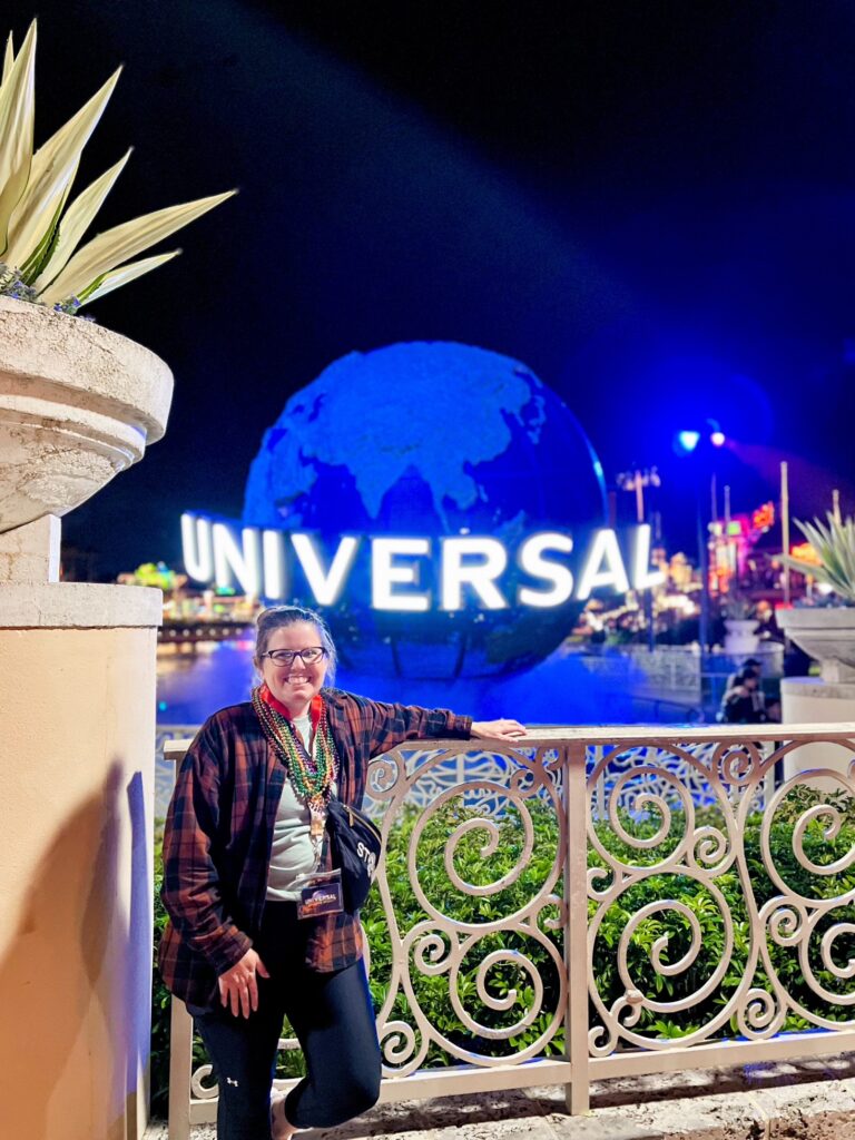 kandee hawbaker in front of the universal globe
