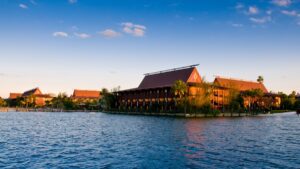 a wideshot of polynesian resort with seven seas lagoon in the foreground